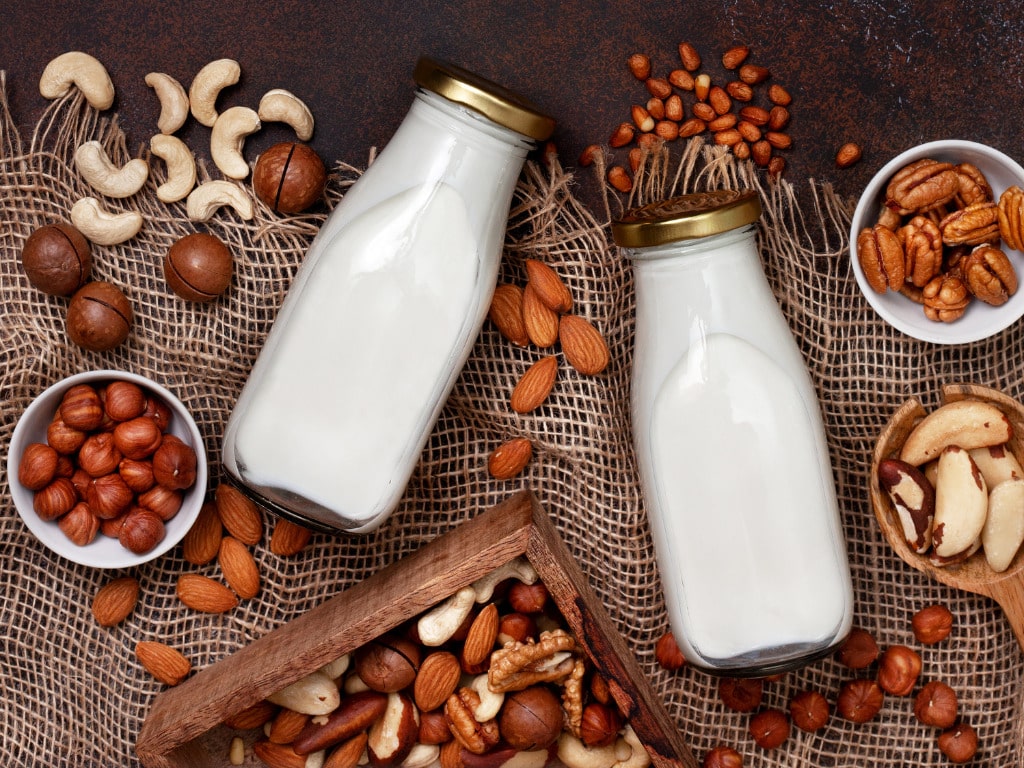 Nuts and Milk on the table with table cloth.